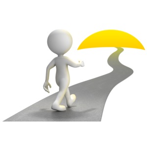 This clip art image shows a figure walking on a path uphill towards a sunset.