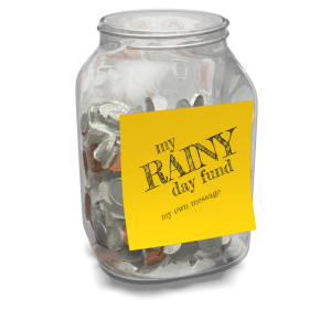A glass jar filled with an assortment of coins with a custom note on the outside of the jar.