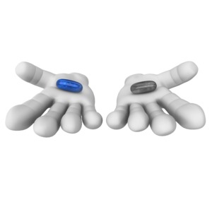 This clip art image shows hands holding out two pills one with color.