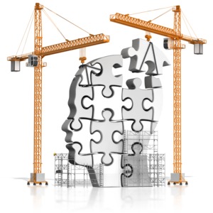 This clip art image shows cranes putting together puzzle pieces that make up a head.