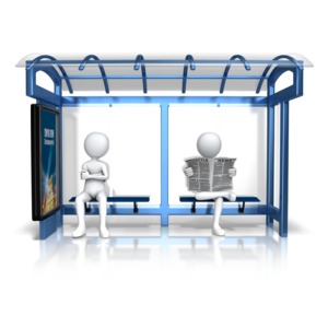 An image of a couple figures waiting at a bus stop.