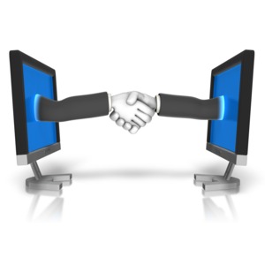 An image of two hands shaking through computer screens.