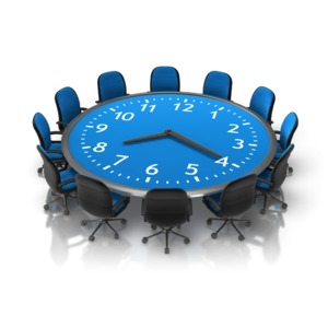 An image of a business table and chairs with a clock incorporated into table. 