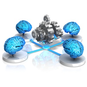 This clip art image shows four brains connected to a center station with a set of gears.