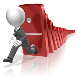 A businessman runs from falling dominos.