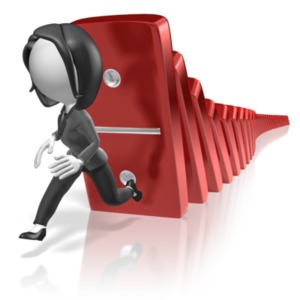 A business woman runs from falling dominos.