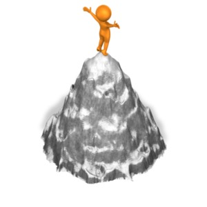 A figure stands proudly on top of a mountain peak.