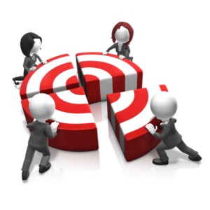 An image of a team of people pushing a target together.