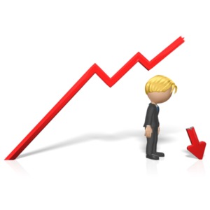 A businessman stares at the end of an arrow graph embedded in the ground.