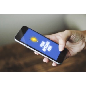 A mobile phone is held by a hand at an angle. You can upload your own screen shot or simply change the text on the phone by using our on-line tools.