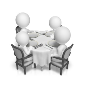 An image of a family sitting down together at a table.