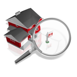 This clip art image shows a magnify glass over a house with a for sale sign in front of it.