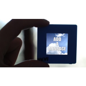 A hand hold up a photographic slide to the light. You can change the message in the slide using our on-line tools.