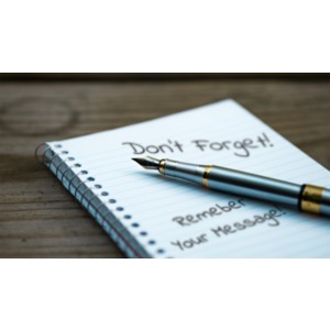 A pen lays on top of a blank notebook.  You can add your own message to the notebook using our on-line tools.