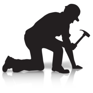 A silhouette of a construction worker hammering down.