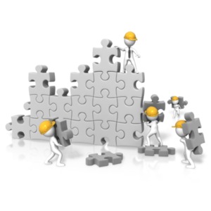 An image of a large puzzle wall with figures working on building it.