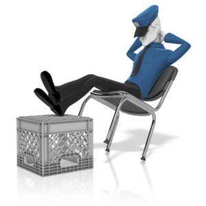 A security guard leans back in his chair with his feet up as he takes a nap.