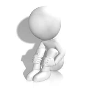 An image of a figure curled up in isolation by a wall.