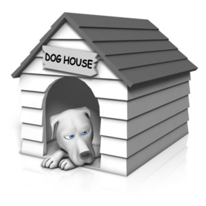 An image of a dog laying down in his doghouse.