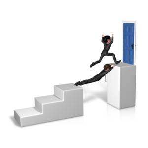 An image of a man running over top of a man bridging the gap to the top step of the door entrance.