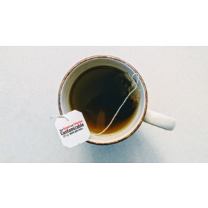 An image from the top view of a cup of tea and a tag that is customizable.