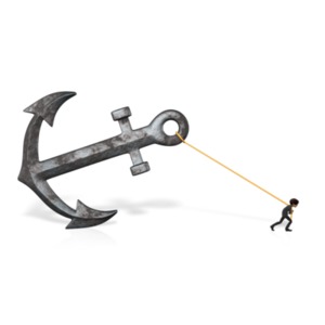 An image of a businessman pulling an over-sized anchor.