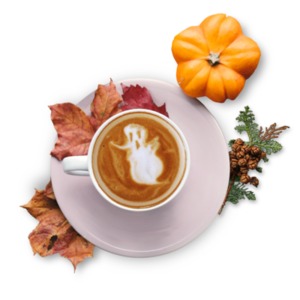 A photograph of a festive fall cup of expresso with a ghost design of the froth.