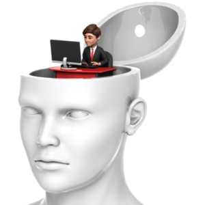 Inside an open head sits a smaller businessman working on a computer at a desk.