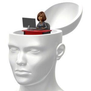 Inside an open head sits a smaller business woman working on a computer at a desk.