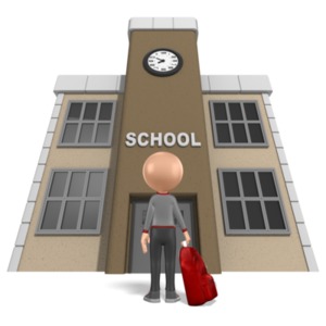 A student stands outside a school building with his backpack.