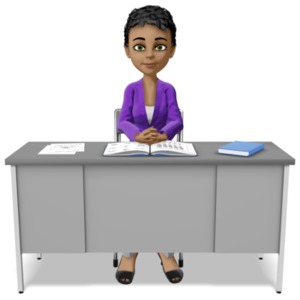 A teacher sits waiting at her desk.