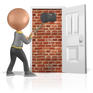 This image shows a figure ready to break down a brick wall with a large sludge hammer.