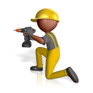 An image of a construction worker kneeling down and using a small electric drill.