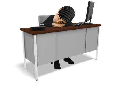 A image of a man with no motivation sleeping at a work desk.