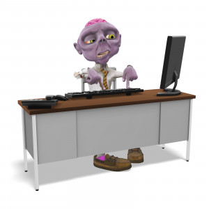In this clipart image, the zombie presentation character Dead Head Fred is sitting at an office desk.  Fred is typing on the keyboard with both index fingers, while looking confused or perplexed.  There is a keyboard, mouse, phone, and monitor on top of the desk.  Use this clipart image for all of your presentation needs involving humor, Halloween, or spooky themes.