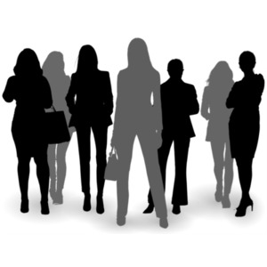A group of seven business women stand posed together in silhouette.