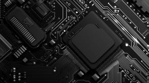 This image features a black circuit board with intricate electronic components and traces. 

