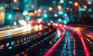 A vibrant night scene of blurred city lights and traffic trails, showcasing urban energy and movement. 

