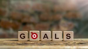 A wooden block display spelling &quot;GOALS&quot; with a target symbol for the letter &quot;O.&quot;

