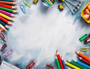 A colorful arrangement of school supplies surrounding a blank space for text or visuals. 

