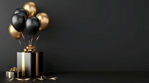 A festive arrangement of black and gold balloons above a stylish gift box on a dark background.