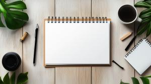 A cozy workspace with a blank notebook, coffee, and greenery, perfect for creative presentations. 

