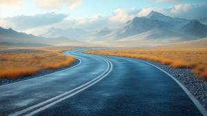 A winding road through a tranquil landscape with mountains and golden grass. 

