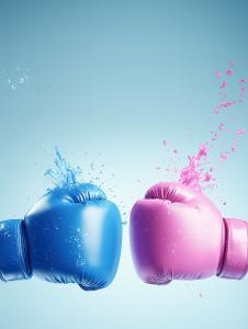 This image shows blue and pink boxing gloves colliding with splashes of water, set against a soft blue background. 

