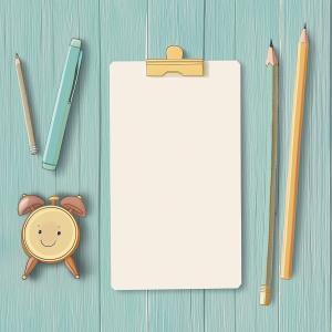 A playful workspace with a clipboard, stationery, and a cheerful alarm clock on a light blue wooden background. 

