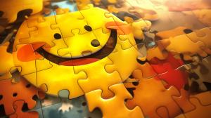 A close-up of a colorful jigsaw puzzle featuring a cheerful yellow smiley face.

