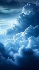 A serene sky filled with soft, billowing clouds in varying shades of blue.

