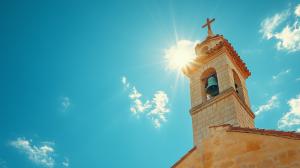 A bright church steeple against a blue sky, symbolizing spirituality and community.

