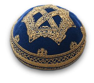 A blue kippah with intricate gold embroidery, symbolizing respect and reverence in Jewish culture.
