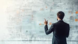 This image depicts a business professional analyzing data visualizations on a digital interface, symbolizing business planning.

